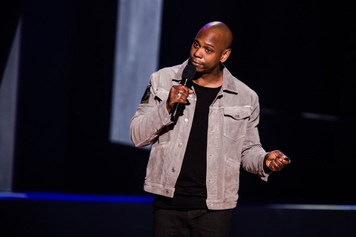 Dave Chappelle on stage in one of his Netflix stand-up specials.